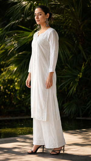 White georgette chikankari kurta with 3/4 sleeves and embroidered hem